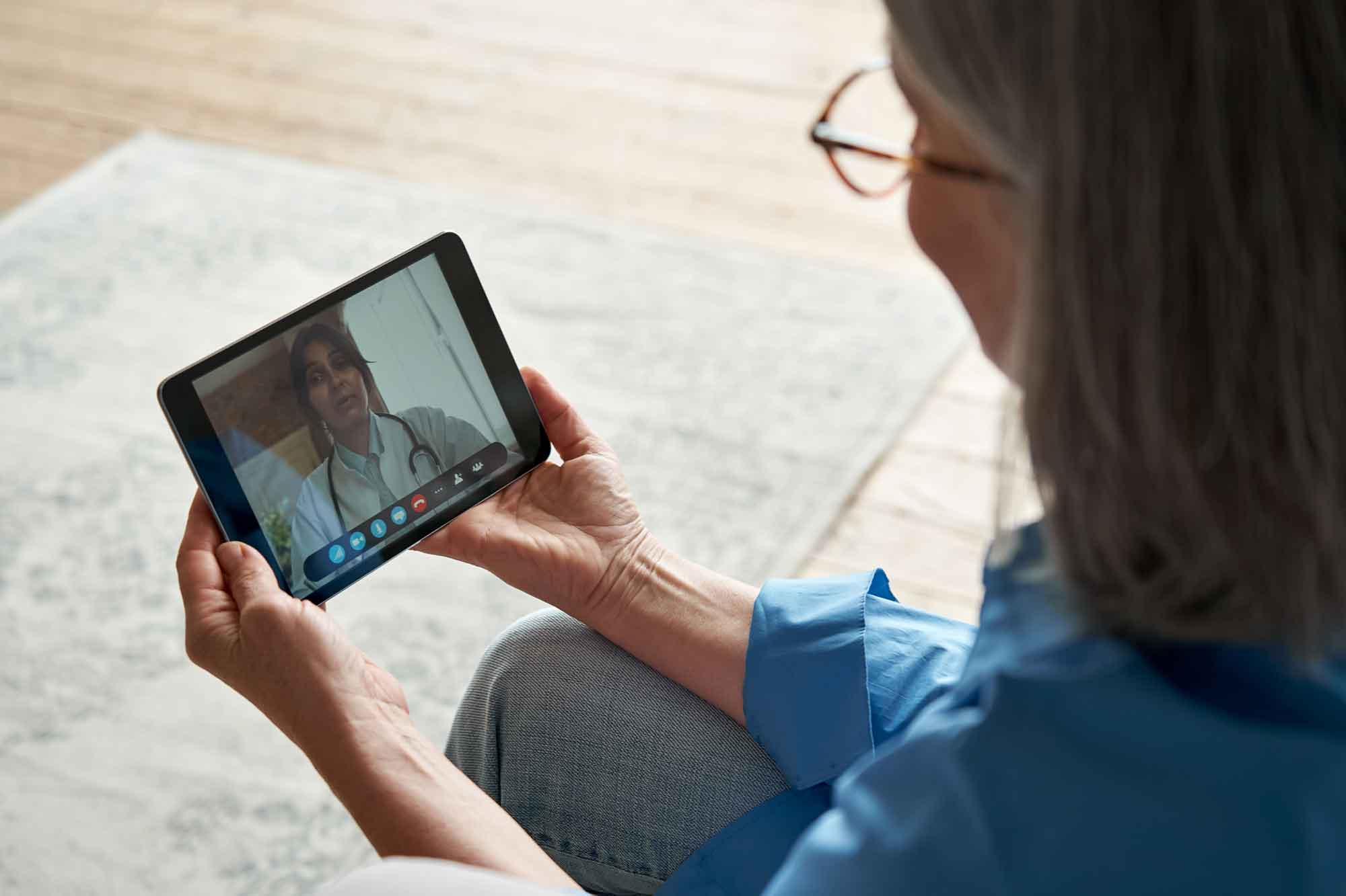 Woman having a medical appointment remotely via video call