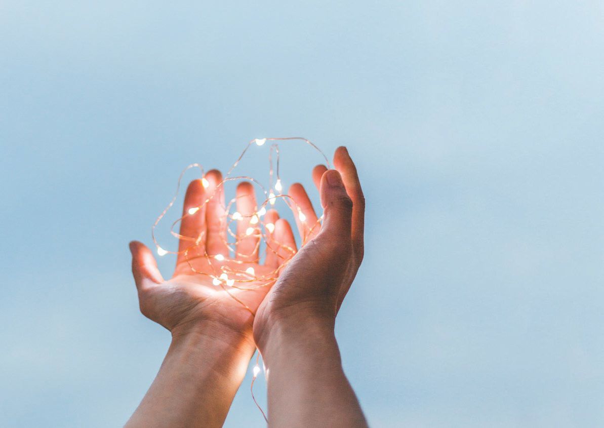 Hands holding glowing lights