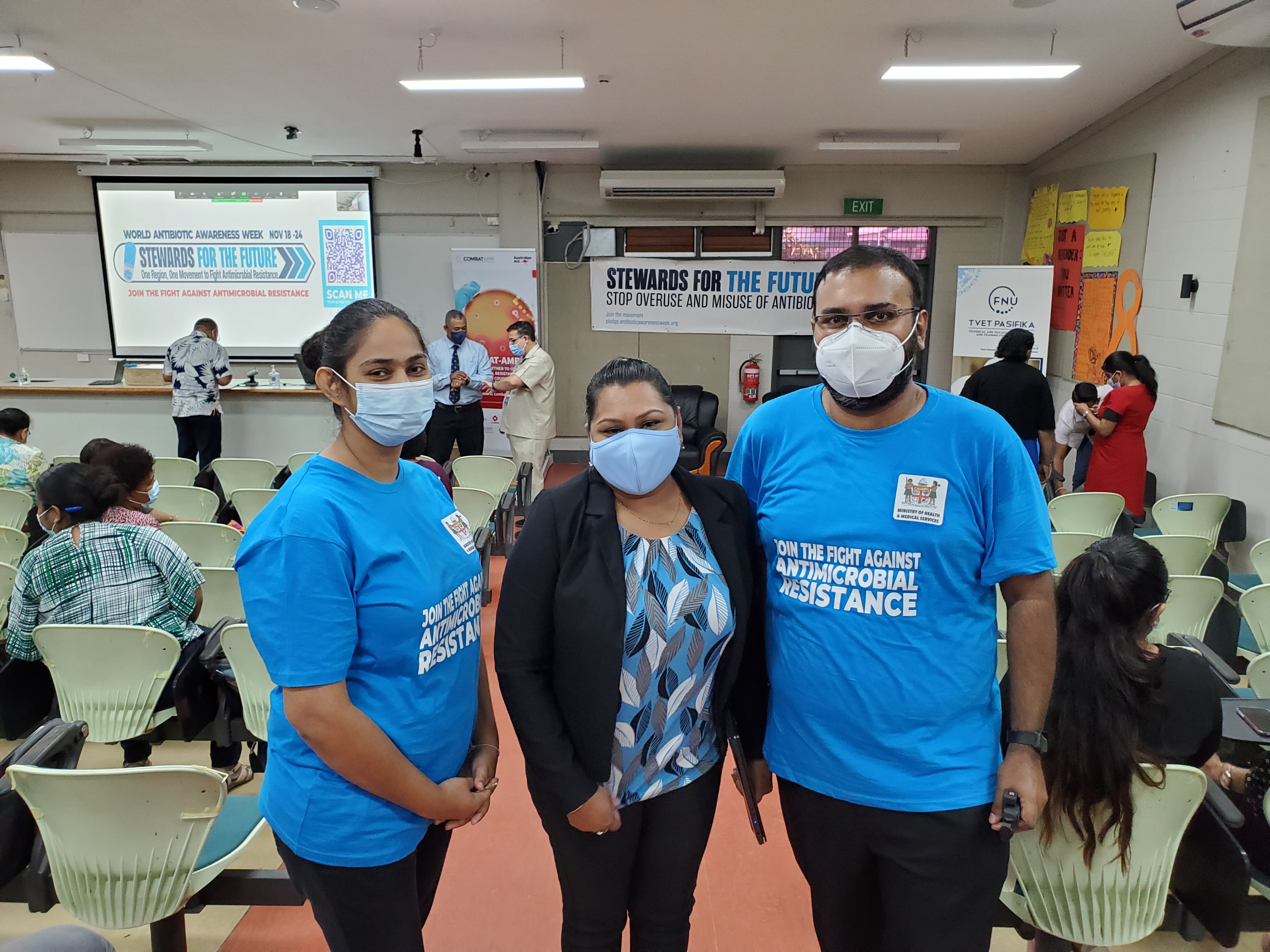 Three people with masks on at AMR event