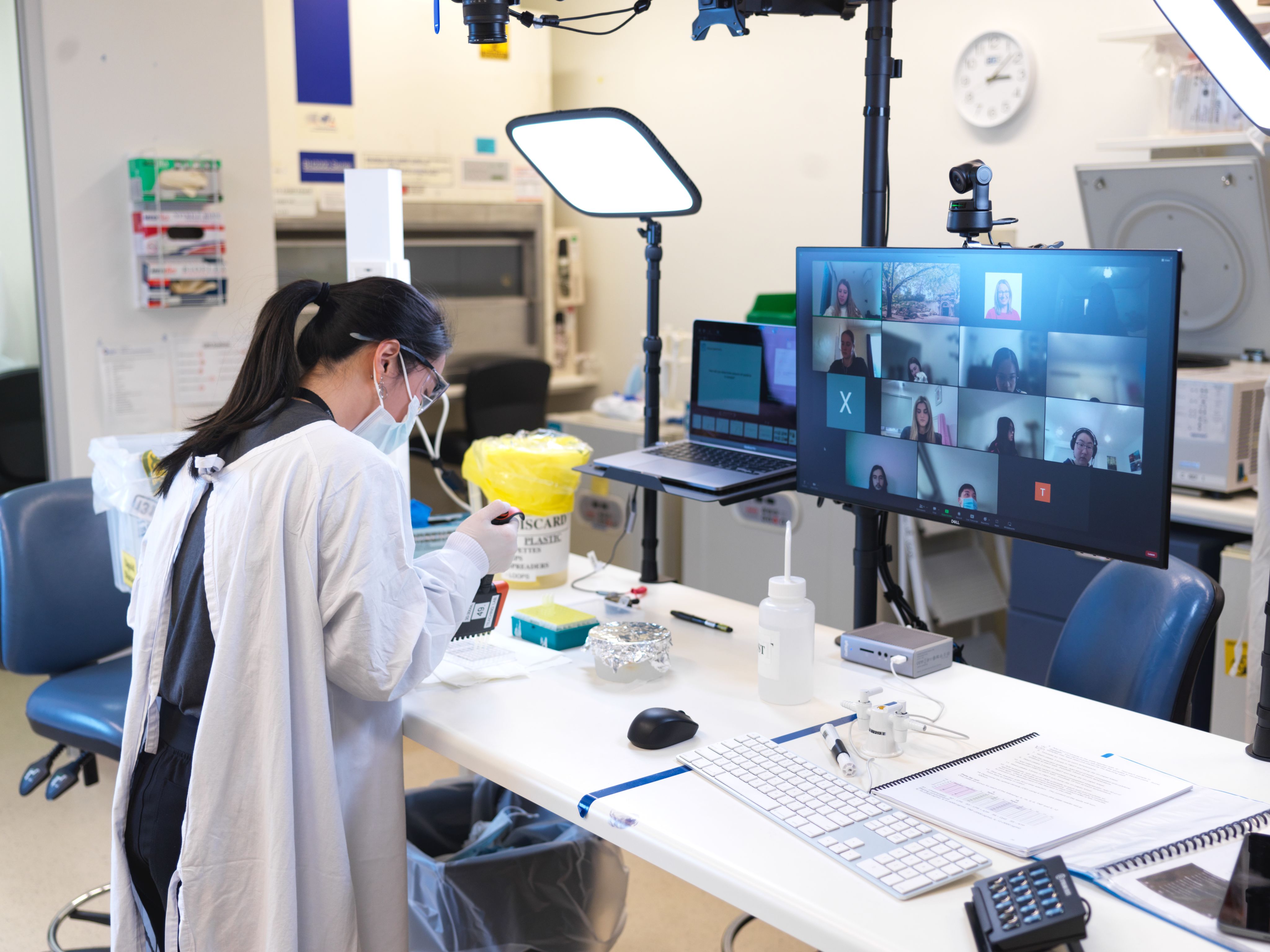 Woman in laboratory teaching remotely.