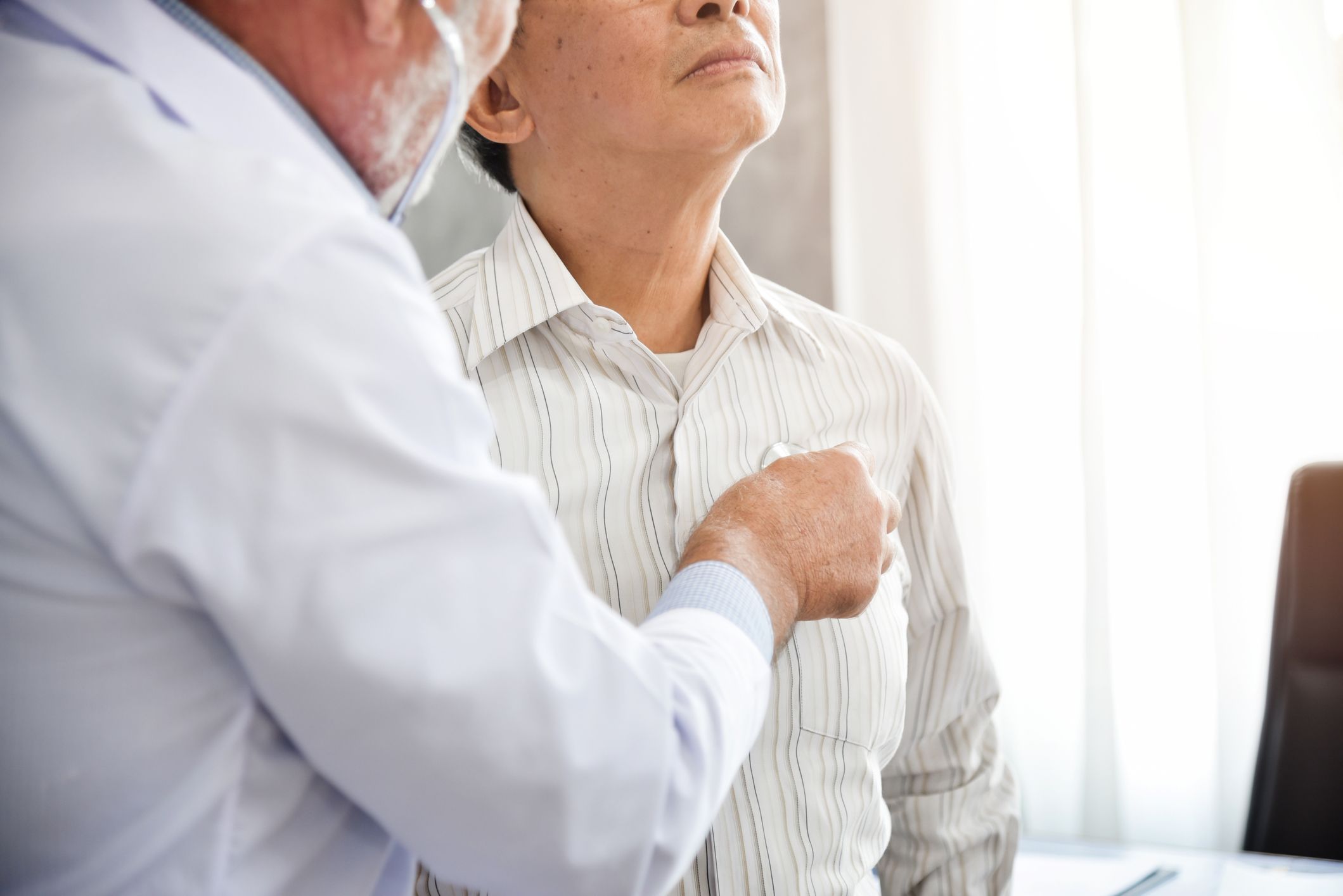 Doctor examining patient with stethoscope